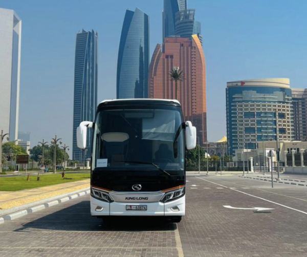 Luxury Coach Bus Service – SSM Chauffeurs Black luxury coach bus with UAE city skyline in background