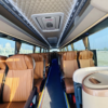 Luxury Coach Bus Interior – SSM Chauffeurs Luxury coach bus interior with tan leather seats and overhead lighting