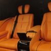 Luxury Van Rear Seating – SSM Chauffeurs Orange leather luxury van rear passenger seats
