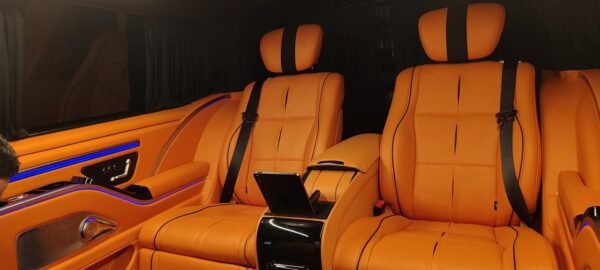 Luxury Van Rear Seating – SSM Chauffeurs Orange leather luxury van rear passenger seats