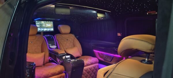 Premium VIP Chauffeur Van Interior – Dubai Luxury VIP van cabin with tan leather seat and ambient lighting