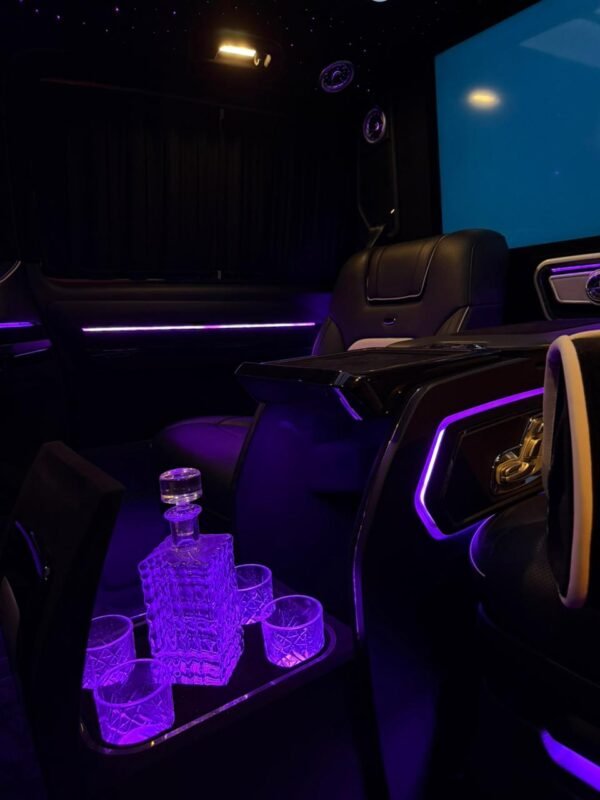 Luxury Chauffeur Van Interior – UAE Luxury van passenger cabin with leather seating and ambient lighting